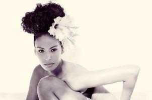 Black woman, model of fashion, with big flowers in her hair photo