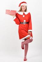 Blonde woman in Santa Claus clothes smiling with gift boxes. photo
