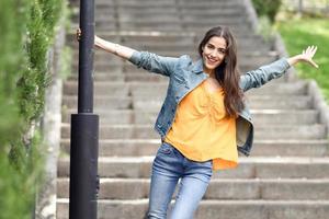 Woman with nice hair wearing casual clothes in urban background. photo