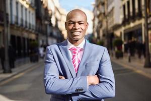 Handsome black man wearing suit in urban background photo