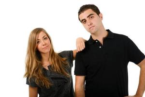 Happy couple laughing at camera on white background photo