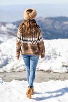 Young woman enjoying the snowy mountains in winter photo