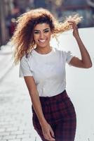 Smiling arab girl in casual clothes in the street. photo