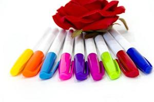 multicolored felt-tip pens on a white background photo