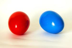 blue and red plastic egg on a white background photo