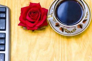 Cup of coffe and open notebook on wooden background photo