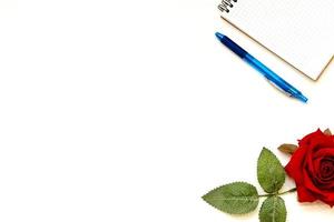 Cup of coffe and open notebook on white background photo