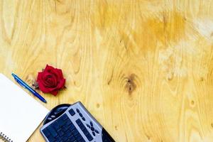 Cup of coffe and open notebook on wooden background photo