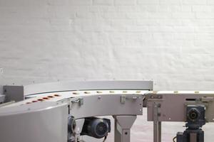 Line for the production of chocolate in an industrial factory. Automatic process in the production line of sweets. Images from the chocolate factory during production. Conveyor belt with sweets. photo