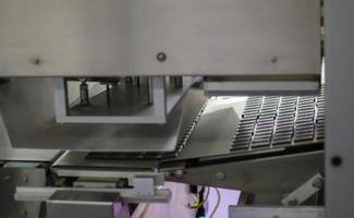 Factory for the production of sweets and chocolate. Automatic line for the production of chocolate in an industrial factory. Conveyor belt with sweets. Sweets production process. Food industry. photo