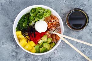 Poke with vegetables and fresh salmon. Studio Photo