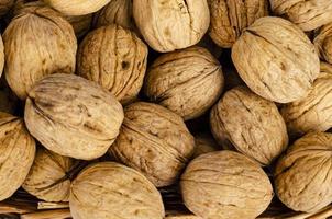 tasty Unpeeled walnuts, background, texture. Studio Photo