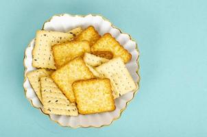 Delicious sweet and savory cookies on blue background. Studio Photo