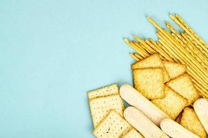 Delicious sweet and savory cookies on blue background. Studio Photo