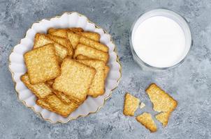 Delicious cookies and glass of milk on bright background. Studio Photo