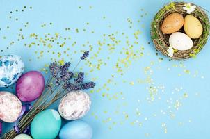 Decorated handmade Easter eggs for the holiday season on blue background. Creative minimal abstract concept. Studio Photo