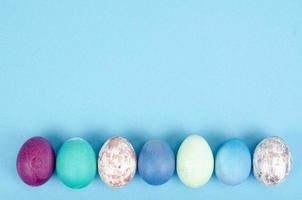 Decorated handmade Easter eggs for the holiday season on blue background. Creative minimal abstract concept. Studio Photo