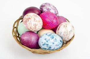 Bright colored Easter eggs on platter, holiday background. Studio Photo