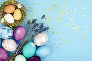 Decorated handmade Easter eggs for the holiday season on blue background. Creative minimal abstract concept. Studio Photo