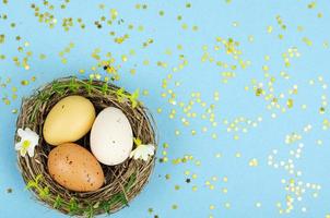 Decorated handmade Easter eggs for the holiday season on blue background. Creative minimal abstract concept. Studio Photo