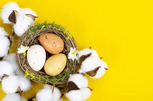 Top view of color easter haqndmade eggs and nest flatlay. Trendy minimal design spring background. Space for text. Stuio Photo