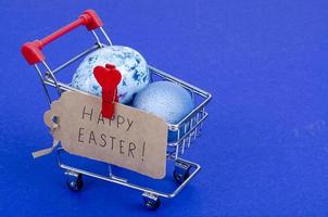 Grocery supermarket cart filled with chicken eggs. Concept of preparing for Easter, buying food. Space for text. Studio Photo