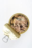 Open metal can with canned fish in its own juice. Studio Photo