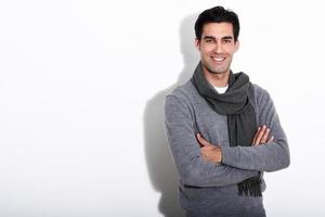 Handsome man wearing winter clothes on white background photo