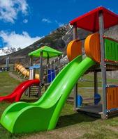 Playground for children with a slide colored green photo