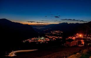 Mountain village illuminated at sunset photo