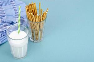 Delicious cookies and glass of milk on bright background. Studio Photo