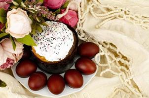 Preparation for celebration of Easter. Homemade cake and red colored eggs. Studio Photo