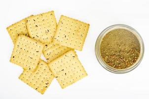 Biscuit cracker with dried herbs and spices on white background. Studio Photo