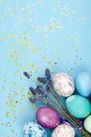 Decorated handmade Easter eggs for the holiday season on blue background. Creative minimal abstract concept. Studio Photo