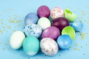Decorated handmade Easter eggs for the holiday season on blue background. Creative minimal abstract concept. Studio Photo