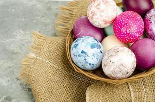Bright colored Easter eggs on platter, holiday background. Studio Photo