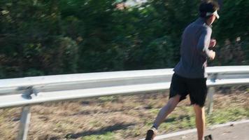 Healthy teenage boys running on the street for exercise. Young male athlete jogging outdoors. Healthy lifestyle concept video