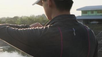 Healthy teenage boys looking at smart watch heart rate monitor. A young male athlete jogging outdoors and checking his progress on a smart watch. Healthy lifestyle concept. video