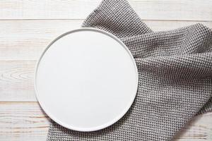 empty white plate tray on tablecloth on wooden table top view photo