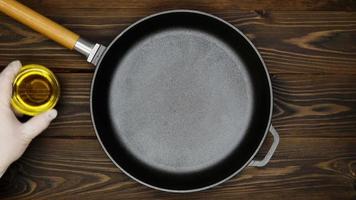 Cast iron pan for frying meat. A professional chef prepares to cooking meat in a skillet. Olive oil, peppers, sauce, lime, herbs and spices for the meat marinating. Top view. Copy space for text video