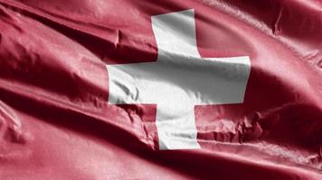 schweiz textilflagga vajande på vindslingan. schweizisk banner vajande på vinden. tyg textilvävnad. full fyllning bakgrund. 10 sekunders loop. video