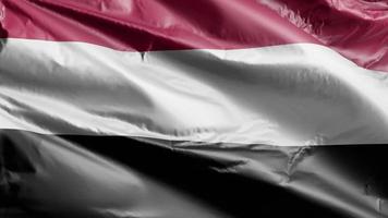 Yemen flag slow waving on the wind loop. Yemen banner smoothly swaying on the breeze. Full filling background. 20 seconds loop. video