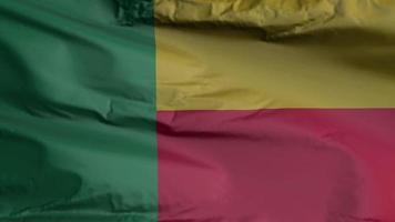 Benin flag seamless closeup waving animation. Benin Background. 3D render, 4k resolution video