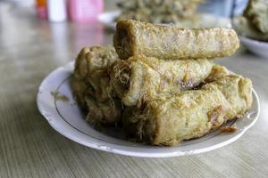 Fried spring rolls or popia or lumpia in white plate photo