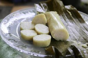 Close up photo of rice cake or commonly called lontong, traditional food wrapped in banana leaf from central java indonesia on a plate