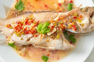 Steamed grouper fish with lime and chillies photo