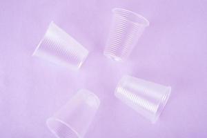 transparent plastic drinks cups on the very peri background. zero waste concept. no plastic. top view. flat lay. photo