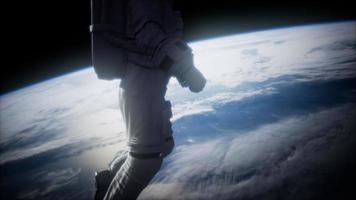 Astronaut in outer space against the backdrop of the planet earth video