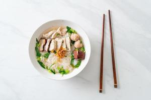 Vietnamese Rice Noodles Soup with Vietnamese Sausage served vegetables and crispy onion photo