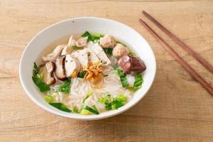 Vietnamese Rice Noodles Soup with Vietnamese Sausage served vegetables and crispy onion photo